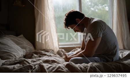 Realistic scene of emotional burnout with muted tones and natural lighting for editorial or stock use 129637495