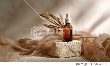 Amber glass dropper bottle styled on limestone block with dried palm, soft textures and natural lighting for organic skincare presentation Amber glass dropper bottle styled on limestone block with dried palm, soft textures and natural lighting for organic skincare presentation 129637600