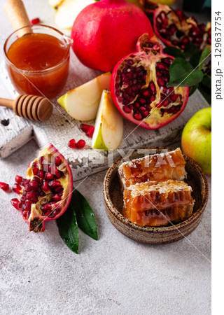 Rosh Hashana concept with honey, apple and pomegranate Rosh Hashana concept with honey, apple and pomegranate 129637754