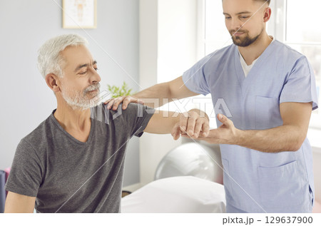 Physiotherapist helps senior man regain elbow mobility during rehabilitation after stroke Physiotherapist helps senior man regain elbow mobility during rehabilitation after stroke 129637900