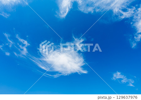 Wispy Clouds in a Clear Blue Sky Above Esna Lock Egypt. 129637976
