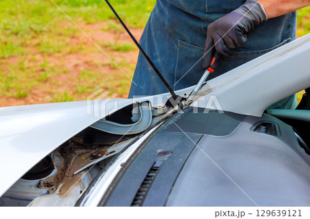 Car maintenance involves checking engine components ensuring everything is functioning properly during windshield repairs Car maintenance involves checking engine components ensuring everything is functioning properly during windshield repairs 129639121