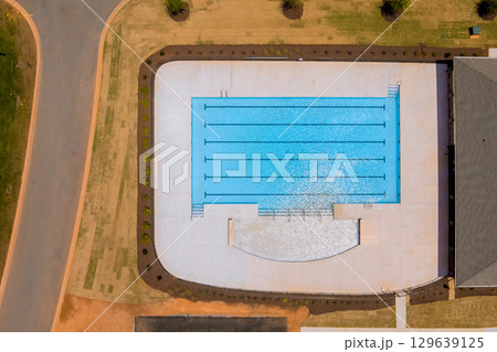 New community swimming pool features multiple lanes spacious deck in suburban area New community swimming pool features multiple lanes spacious deck in suburban area 129639125