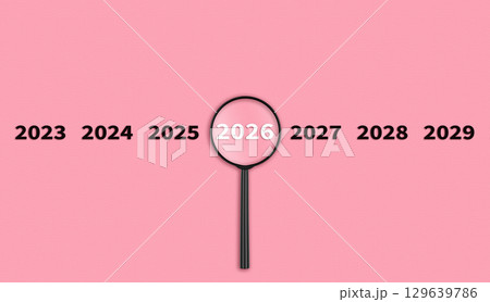 Lens, magnifying glass focusing on the year 2026 on a red background. Financial or stock market strategies and past and future events. Lens, magnifying glass focusing on the year 2026 on a red background. Financial or stock market strategies and past and future events. 129639786