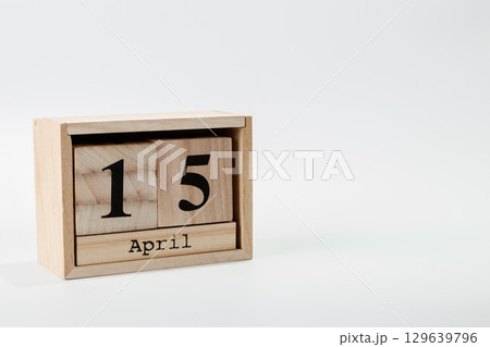 Wooden calendar April 15 on a white background 129639796