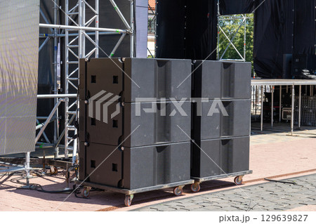 Professional concert acoustic systems set up on an open-air stage Professional concert acoustic systems set up on an open-air stage 129639827