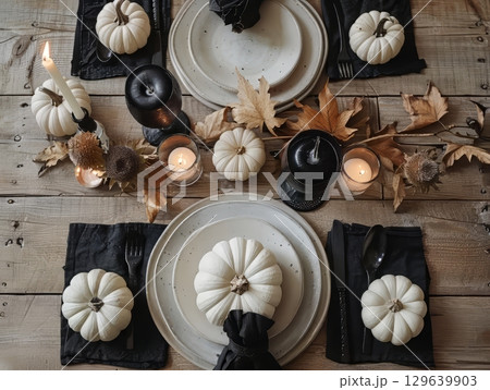 Autumn Table Setting with White Pumpkins and Black Cutlery 129639903