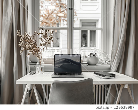 Cozy home office with laptop by the window Cozy home office with laptop by the window 129639997