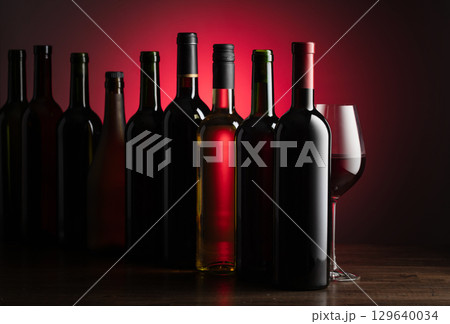 Bottles of wine on a old wooden table. 129640034