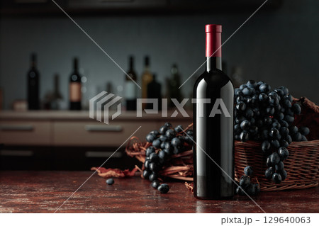 Bottle of red wine with blue grapes. Bottle of red wine with blue grapes. 129640063