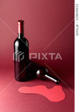 Bottles of red wine on a red background. 129640072