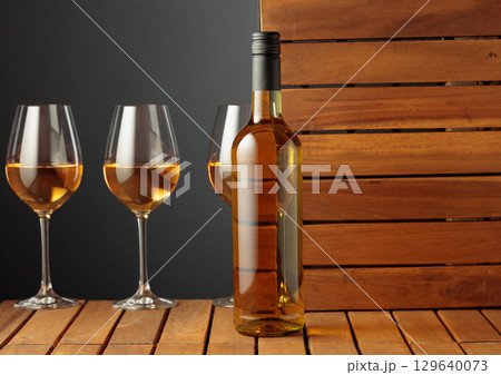 White wine on a wooden background. 129640073