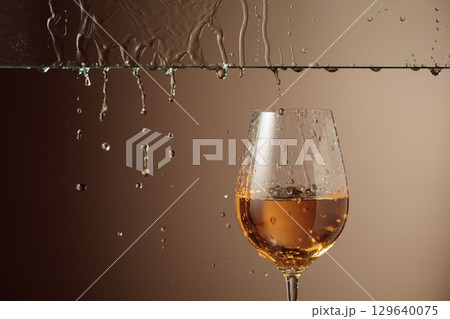 White wine flows down into a glass. White wine flows down into a glass. 129640075