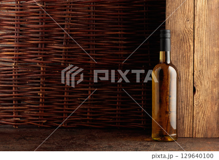 Bottle of white wine on a vintage background. 129640100