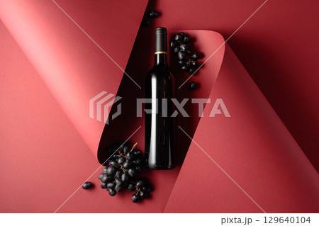 Bottle of red wine and blue grapes. Bottle of red wine and blue grapes. 129640104