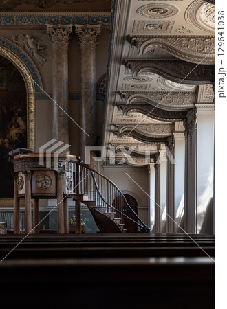 the ornately carved wooden staircase that gracefully ascends to the pulpit interior of the Chapel of St Peter & St Paul. 129641038