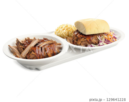 Pulled Pork BBQ Plate A plate of pulled pork with BBQ sauce, coleslaw, and cornbread. The pork has a smoky, 129641228