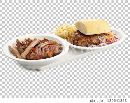 Pulled Pork BBQ Plate A plate of pulled pork with BBQ sauce, coleslaw, and cornbread. The pork has a smoky, 129641228