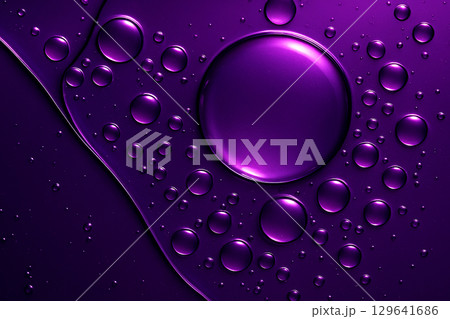Artistic close-up of vibrant purple oil droplet with smooth curved edges against dark background 129641686