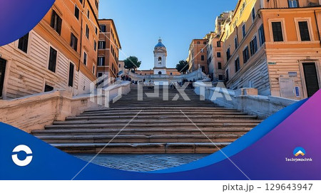 Historic city staircase leading to clock tower under sunny sky 129643947