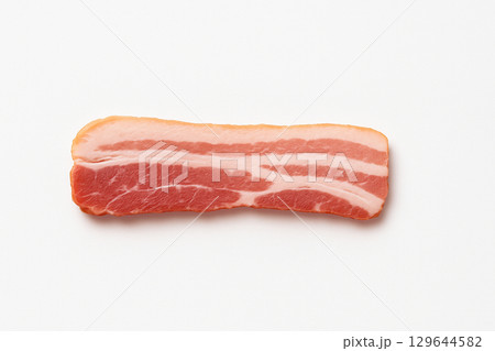 白い背景に置かれたシンプルな生ベーコンスライス 129644582