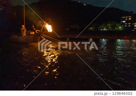 岐阜県岐阜市　篝火を焚いて長良川で行われる長良川鵜飼の鵜匠と鵜 129646502