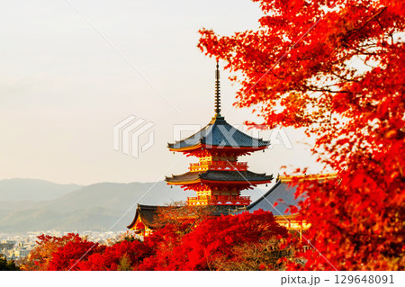 Kiyomizu dera orange pagoda with red maple autumn leaf at sunset, Kyoto Kiyomizu dera orange pagoda with red maple autumn leaf at sunset, Kyoto 129648091