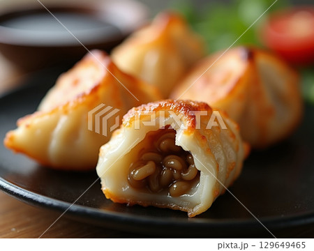 Delicious Golden Brown Pan Fried Chinese Dumpling Appetizer Dish 129649465