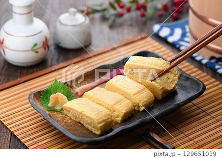 出来立て熱々の出汁巻き卵　和食の定番料理　家庭料理や居酒屋メニューに最適な食卓イメージ 129651019