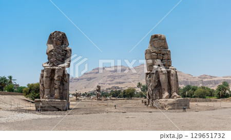 The Colossi of Memnon Standing Against a Mountainous Backdrop 129651732