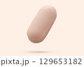 Pink medicine pill tablet float on beige background 129653182