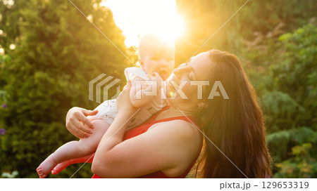 Sunburst giggles and a baby's open mouthed wonder 129653319