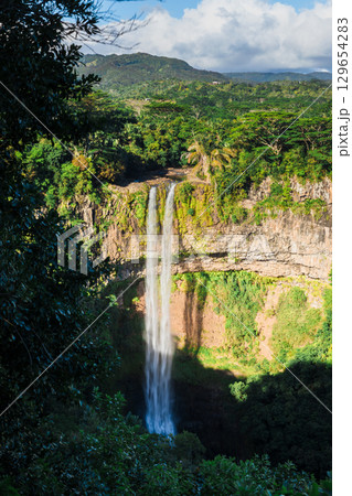 Highest Chamarel waterfall of Mauritius in the tropical jungle Highest Chamarel waterfall of Mauritius in the tropical jungle 129654283
