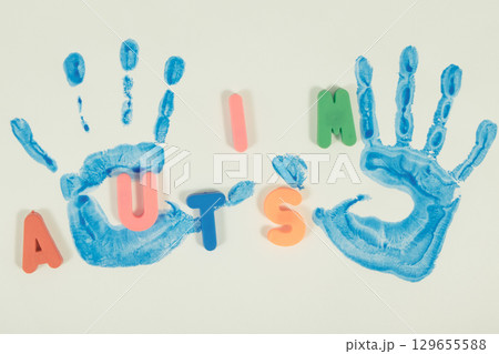Kid handprint made of paint on white background. Autism spectrum disorder. Autism awareness 129655588