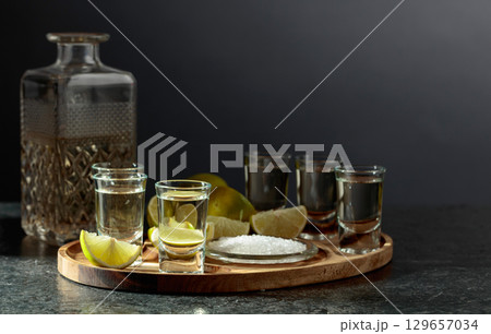 Gold tequila with salt and lime slices. 129657034