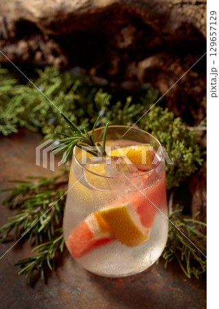 Refreshing hard seltzer with ice, grapefruit, and rosemary. 129657129