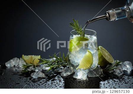 Gin and tonic cocktail made with dry gin, tonic water, lime, and ice. Gin and tonic cocktail made with dry gin, tonic water, lime, and ice. 129657130