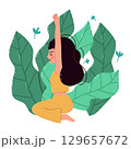 Young Woman Meditating Outdoors Surrounded by Tropical Greenery 129657672