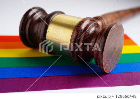 Gavel for judge lawyer on rainbow flag, symbol of LGBT pride month. 129660449