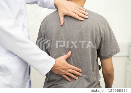 Physical therapy, Asian therapist doctor treat perform pain young man in hospital. 129660553