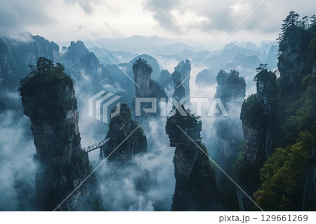 Suspended Bridge Amid Towering Peaks and Ethereal Misty Valleys at Dawn. Generative AI 129661269