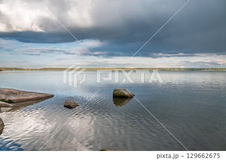 Blue lake with cloudy sky, natural background 129662675