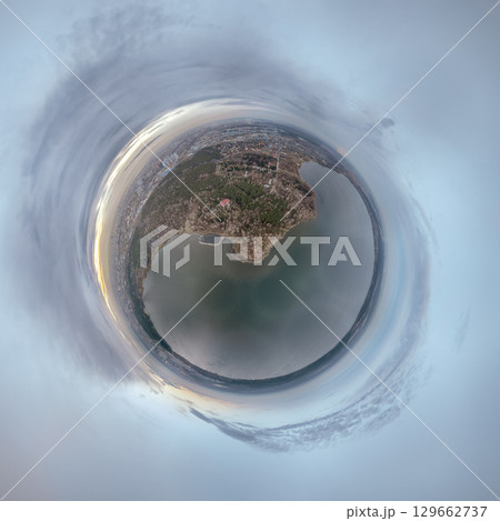 Big lake with green shores in bright sun light, aerial landscape. Recreation concept. Aerial view. Little planet sphere mode. 129662737