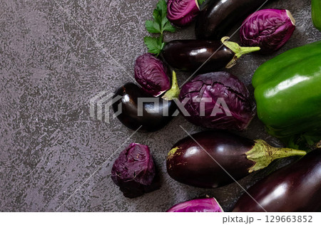 A variety of green peppers, cabbage and eggplant on the background of the old texture. Diet. Healthy eating theme background. View from above 129663852