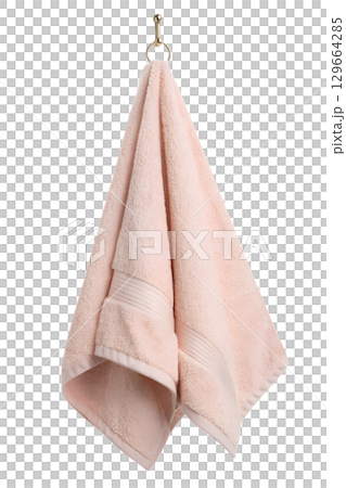 Soft pink cotton towel hanging on wooden hook, bathroom linen isolated Soft pink cotton towel hanging on wooden hook, bathroom linen isolated 129664285