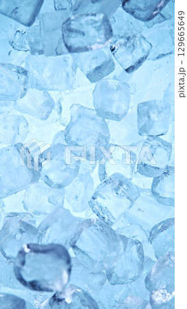 Ice Cubes. Textured Ice on a Blue Background, Close-up. Abstract Background, Flying Ice. Vertical Aspect Ratio. Ice Cubes. Textured Ice on a Blue Background, Close-up. Abstract Background, Flying Ice. Vertical Aspect Ratio. 129665649