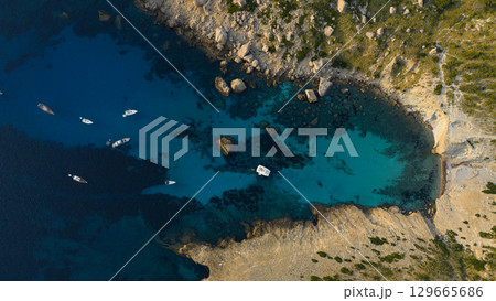Aerial view of beautiful bay with turquoise water and longtail boats anchoring. Travel photo, Mallorca, Spain. 129665686