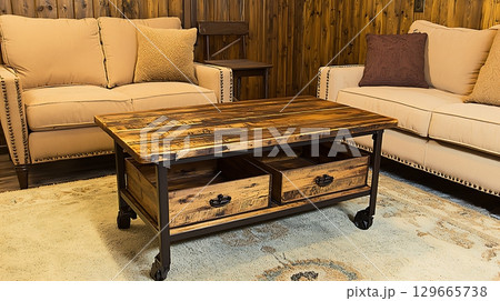 Living room with a brown wooden coffee table and two couches 129665738