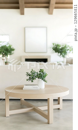 White coffee table with a vase of green plants and a book on top White coffee table with a vase of green plants and a book on top 129665811
