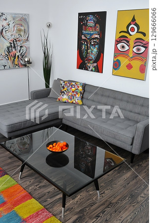 A living room with a gray couch and a black coffee table 129666066